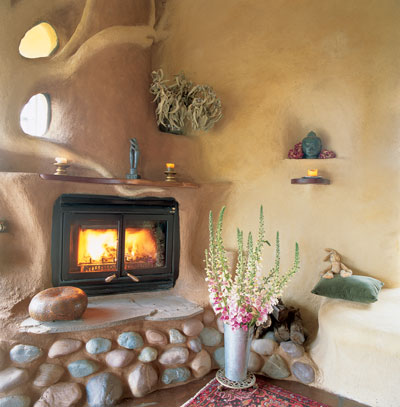 Annie and Patsy built the rough cob structure, then builder Tim Owen-Kennedy sculpted this fireplace, built on top of a standard metal box fireplace and flue.